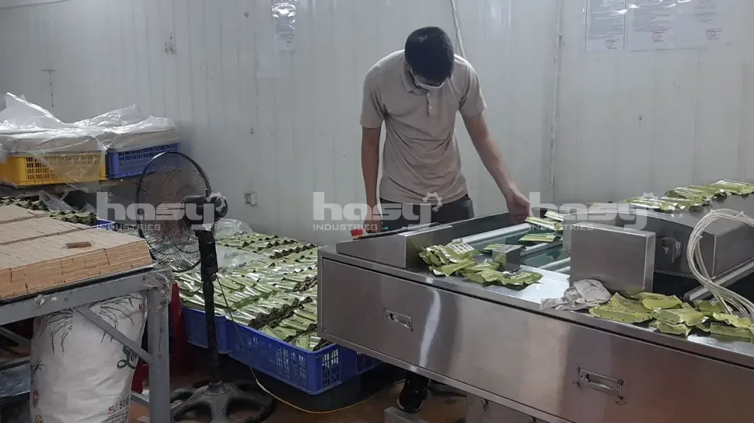 Công nhân cấp túi vào máy hút chân không